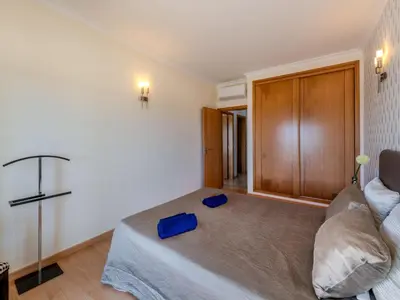 a bedroom with a bed and a couch at Holiday Home Encosta dos Salgados by Interhome in Galé
