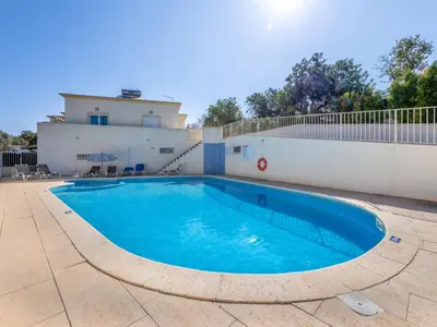 a swimming pool in front of a building at Holiday Home Encosta dos Salgados by Interhome in Galé