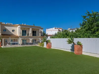 a house with a white fence and a yard at Holiday Home Encosta dos Salgados by Interhome in Galé