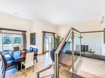 a dining room and living room with a table and chairs at Holiday Home Encosta dos Salgados by Interhome in Galé