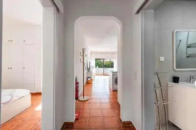 a room with a hallway with a bed and a mirror at Pateo Apartment - One Bedroom in Albufeira in Albufeira