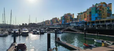 a group of boats docked in a harbor with buildings at Pateo Apartment - One Bedroom in Albufeira in Albufeira