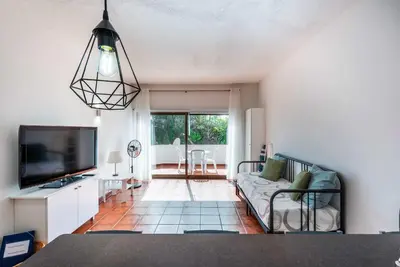 a living room with a couch and a tv at Pateo Apartment - One Bedroom in Albufeira in Albufeira