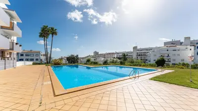 a swimming pool in front of a building at Sunny Retreat with Pool and Balcony by LovelyStay in Albufeira