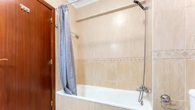 a bathroom with a shower with a glass door at Sunny Retreat with Pool and Balcony by LovelyStay in Albufeira
