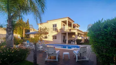 a villa with a swimming pool and a house at Sunshine by Check-in Portugal in Albufeira