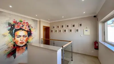 a room with a large painting of a woman at Sunshine by Check-in Portugal in Albufeira