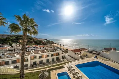 a view of the beach from a building with a swimming pool at Varandas do Mar, Olhos de Agua, 1 Bed Apt AT23 in Olhos de Água