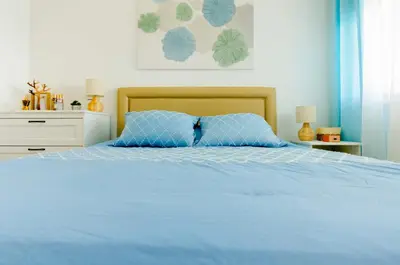 a bedroom with a blue bed with a blue pillow at Varandas do Mar, Olhos de Agua, 1 Bed Apt AT23 in Olhos de Água