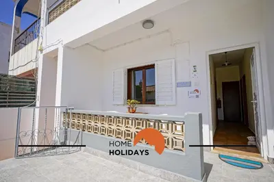 a white building with a home holidays sign on it at #241 Old Town - Casa de Albufeira 1 by Home Holidays in Albufeira