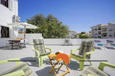 two chairs and a table on a patio at #241 Old Town - Casa de Albufeira 1 by Home Holidays in Albufeira