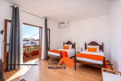 two beds in a room with a window at #242 Old Town - Casa de Albufeira 2 by Home Holidays in Albufeira