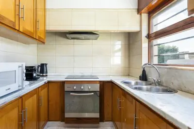 a small kitchen with a sink and a stove at TAC - Villa Oura in Albufeira