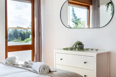 a bedroom with a mirror and a bed with a dresser at TAC - Villa Oura in Albufeira