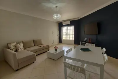 a living room with a couch and a table at 3 Bed Vacation home in Quarteira in Quarteira