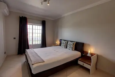 a bedroom with a large bed and a window at 3 Bed Vacation home in Quarteira in Quarteira