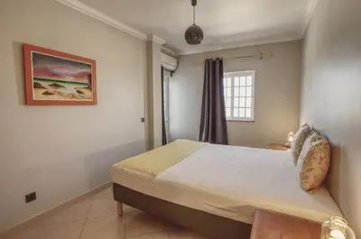 a bedroom with a bed and a window at 3 Bed Vacation home in Quarteira in Quarteira