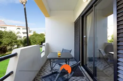 a small table on the balcony of a house at #287 Rodrimar Studio 212 by Home Holidays in Albufeira