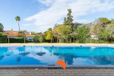 a swimming pool in front of a house at #287 Rodrimar Studio 212 by Home Holidays in Albufeira