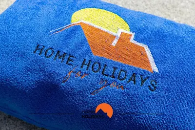 a blue towel with the words home holidays on it at #287 Rodrimar Studio 212 by Home Holidays in Albufeira