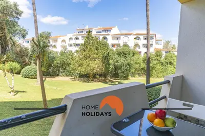 a bowl of fruit on a balcony with a sign that says home holidays at #287 Rodrimar Studio 212 by Home Holidays in Albufeira
