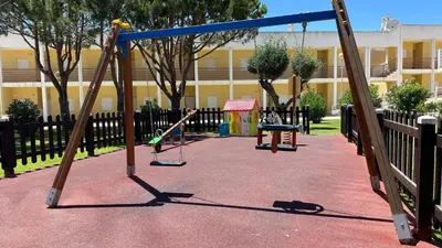 an empty playground with a swing set and a swing at Apartment Josefa in Albufeira