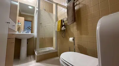a bathroom with a toilet and a sink and a shower at Apartment Josefa in Albufeira