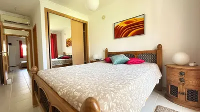 a bedroom with a large bed and a mirror at Apartment Josefa in Albufeira