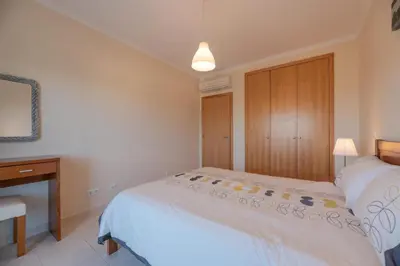 a bedroom with a bed and a dresser and a bed at Vista das Ondas 208 by JS in Olhos de Água