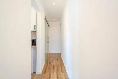 a hallway with white walls and a wooden floor at Galé Beach Studio - Albufeira - Sea View in Guia