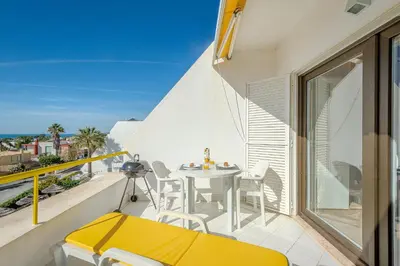 a small balcony with a table and chairs on a building at Galé Beach Studio - Albufeira - Sea View in Guia