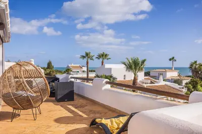 a balcony with a view of the ocean at Villa Coral by OCvillas in Albufeira