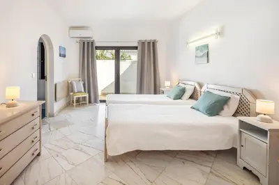 a bedroom with two beds in a room at Villa Coral by OCvillas in Albufeira