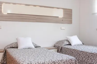 a white bathroom with a toilet and a sink at Casa da Praia by OCvillas in Albufeira