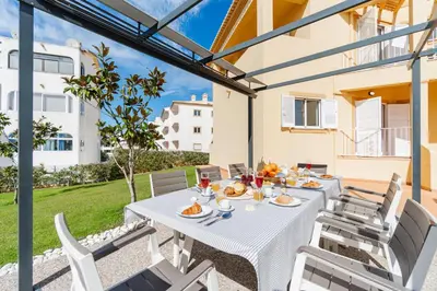 a table and chairs on the patio of a house at Casa da Praia by OCvillas in Albufeira