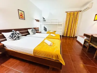 a bedroom with two beds and a desk at Resort Albufeira Praia Oura in Albufeira