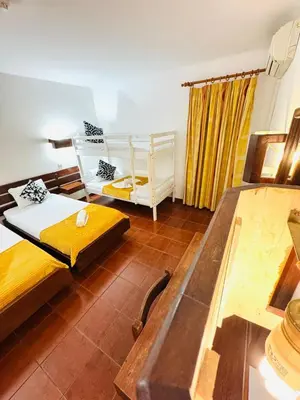 a living room with two beds and a couch at Resort Albufeira Praia Oura in Albufeira