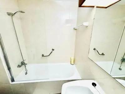 a bathroom with a shower and a toilet at Resort Albufeira Praia Oura in Albufeira