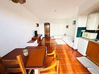 a kitchen and dining room with a table and chairs at Resort Albufeira Praia Oura in Albufeira
