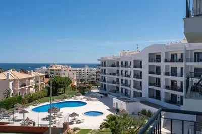 a view from the balcony of a building with a swimming pool at Vista das ondas 205 by AS in Olhos de Água