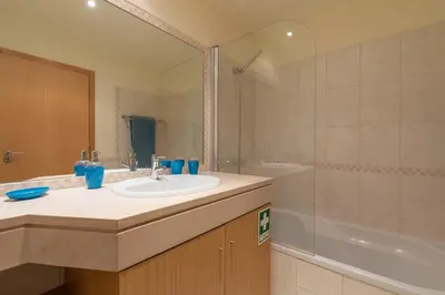 a bathroom with a sink and a shower and a tub at Vista das ondas 205 by AS in Olhos de Água