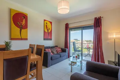 a living room with a couch and a table at Vista das ondas 205 by AS in Olhos de Água