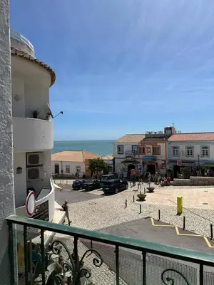 a person walking in a parking lot next to a building at Cosy 3 bed Apartment Albufeira Old town in Albufeira