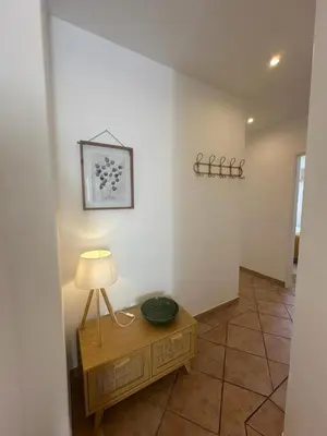 a room with a table with a lamp on it at Cosy 3 bed Apartment Albufeira Old town in Albufeira