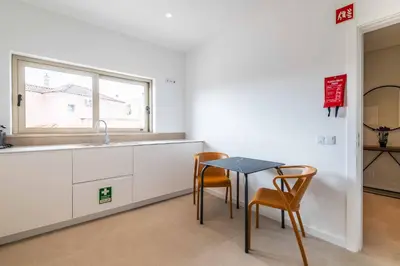 a kitchen with a table and two chairs and a sink at DK Stays Residences Albufeira in Albufeira