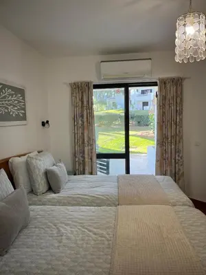 a kitchen with white cabinets and a stainless steel refrigerator at Superior Apartment 361 Balaia Golf Village in Olhos de Água
