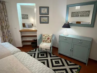 a table with a lamp and a flag on it at Superior Apartment 361 Balaia Golf Village in Olhos de Água