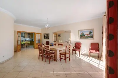 a kitchen and dining room with a table and chairs at Solar das Andorinhas in Albufeira