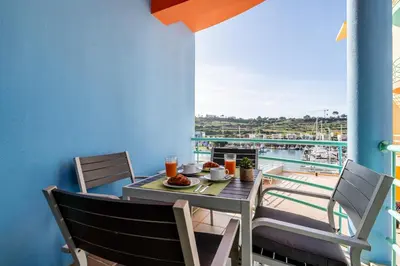 a table and chairs on a balcony with a view of the water at Marina 4B 1D By RS in Albufeira