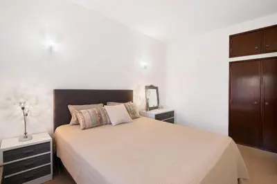 a bedroom with a bed and two night stands at Apartament Dita in Albufeira